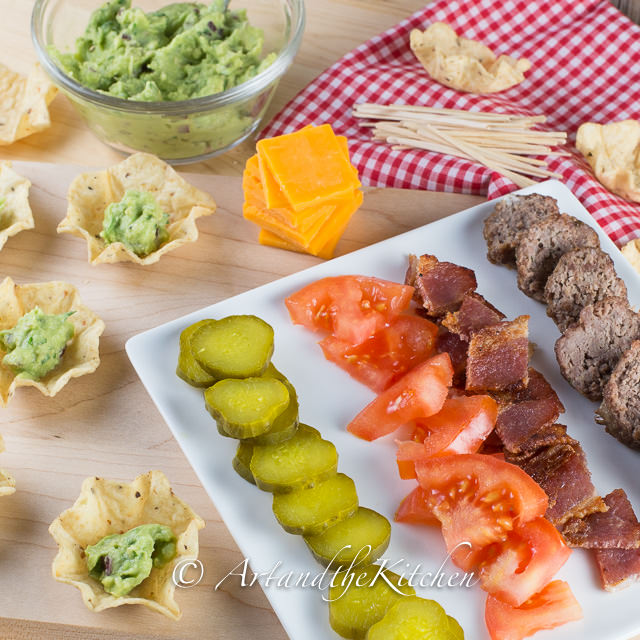 Put a scoop of guacamole into each tostitos scoop, place skewer of
