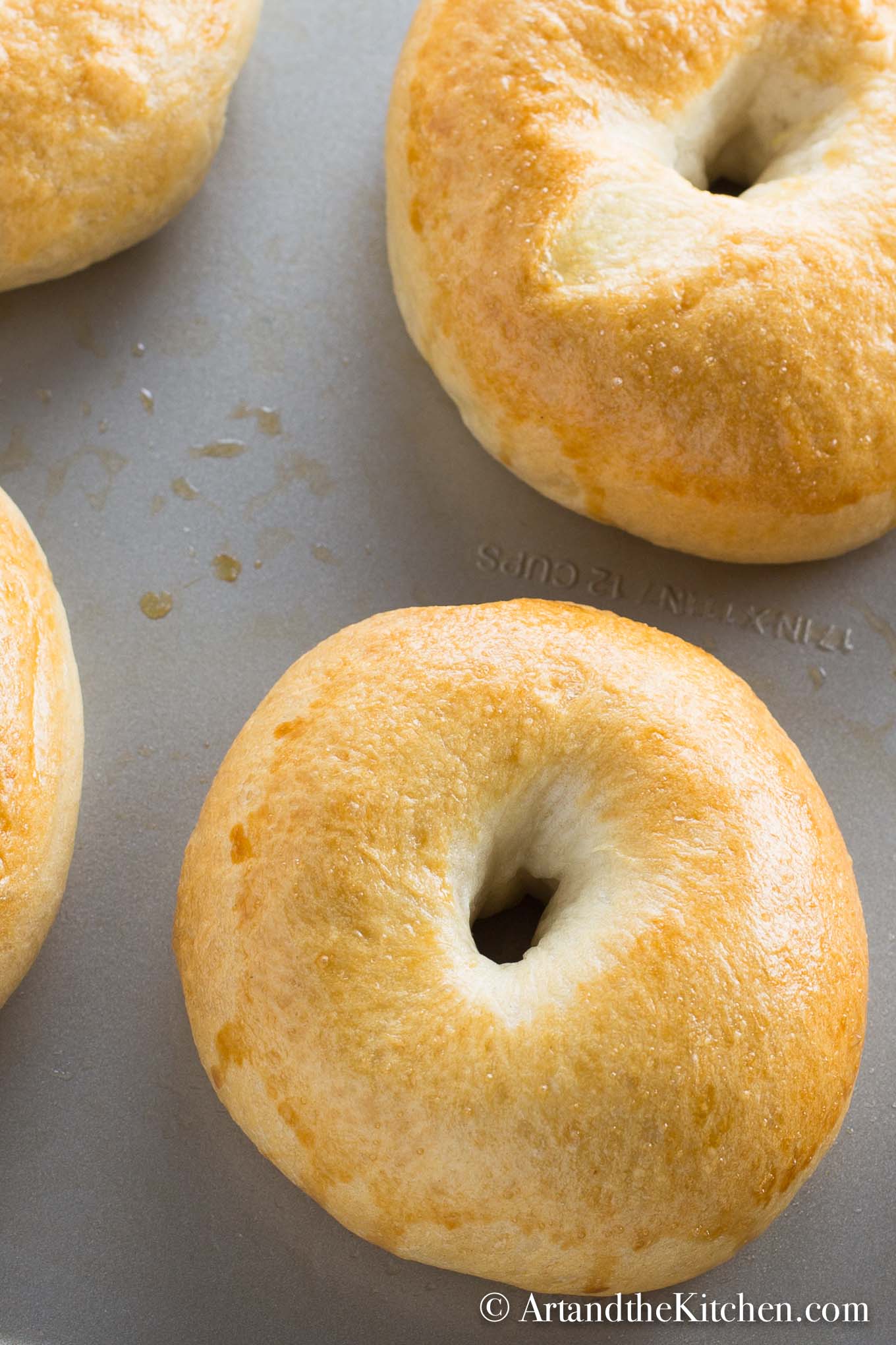 fresh baked, golden brown bagels on baking sheet. Made using a bread machine.