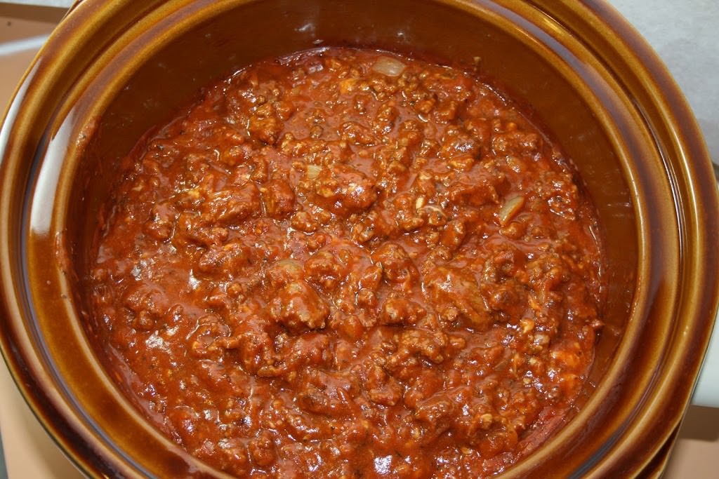 slow cooker filled with thick, meaty spaghetti sauce