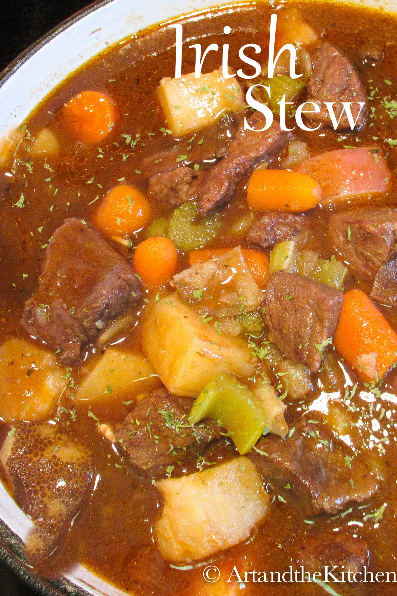 Irish Stew cooking in a dutch oven loaded with beef, potatoes and carrots.