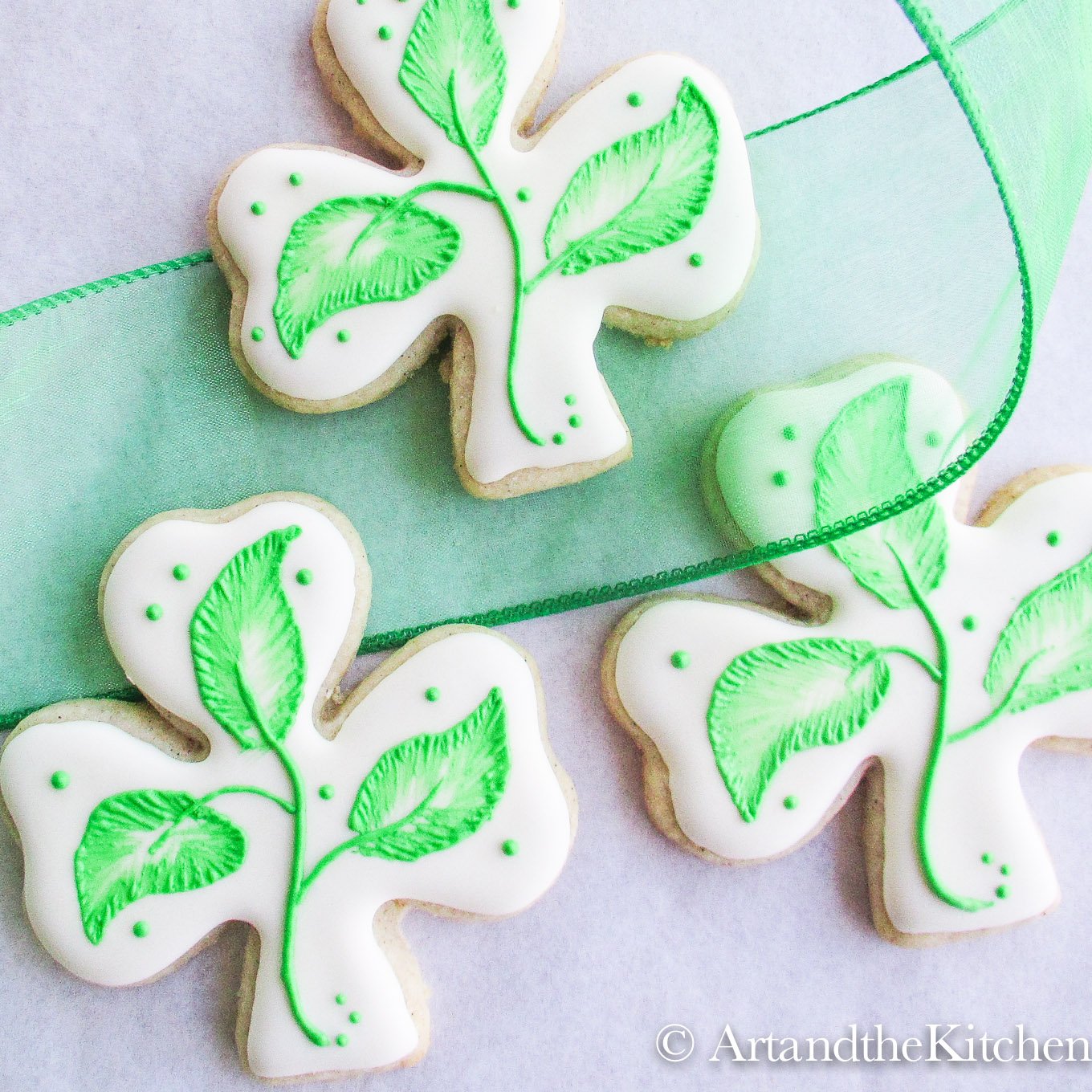 Clover shaped cookies decorated with royal icing.