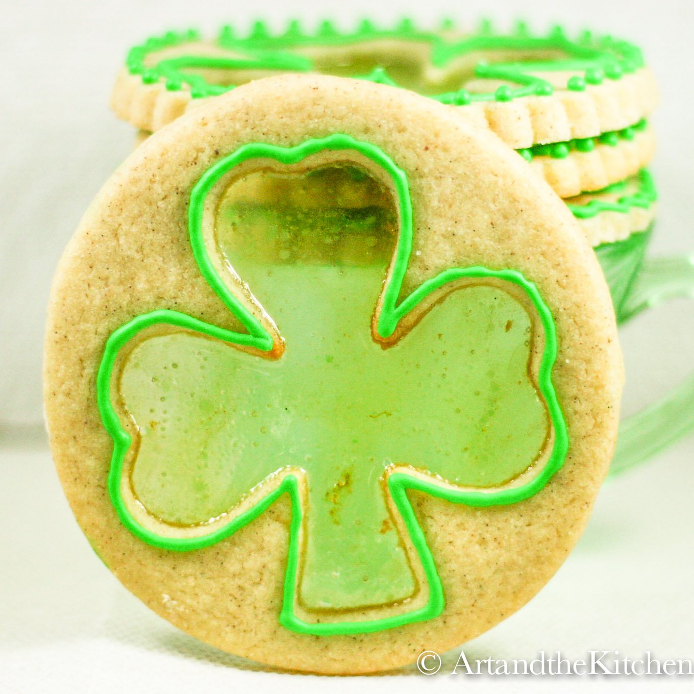 Shamrock shaped cookie with stained glass candy effect.