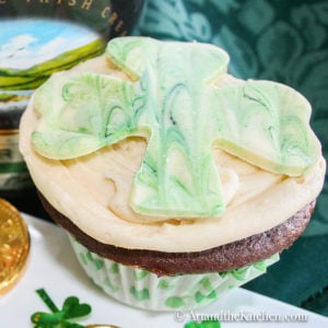 chocolate cupcake with green tinted white chocolate Shamrock on top.