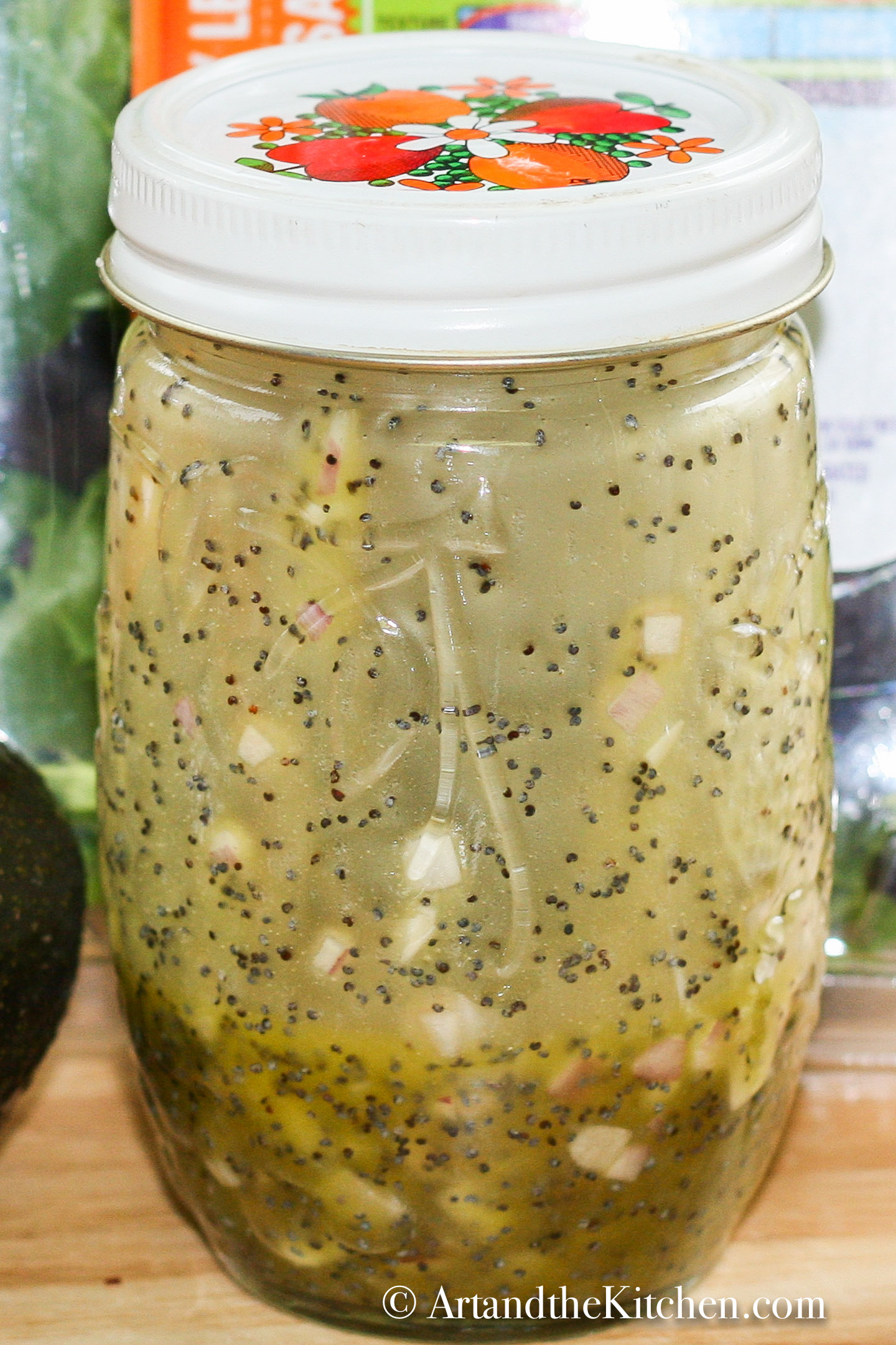 A small glass jar filled with homemade poppyseed dressing.