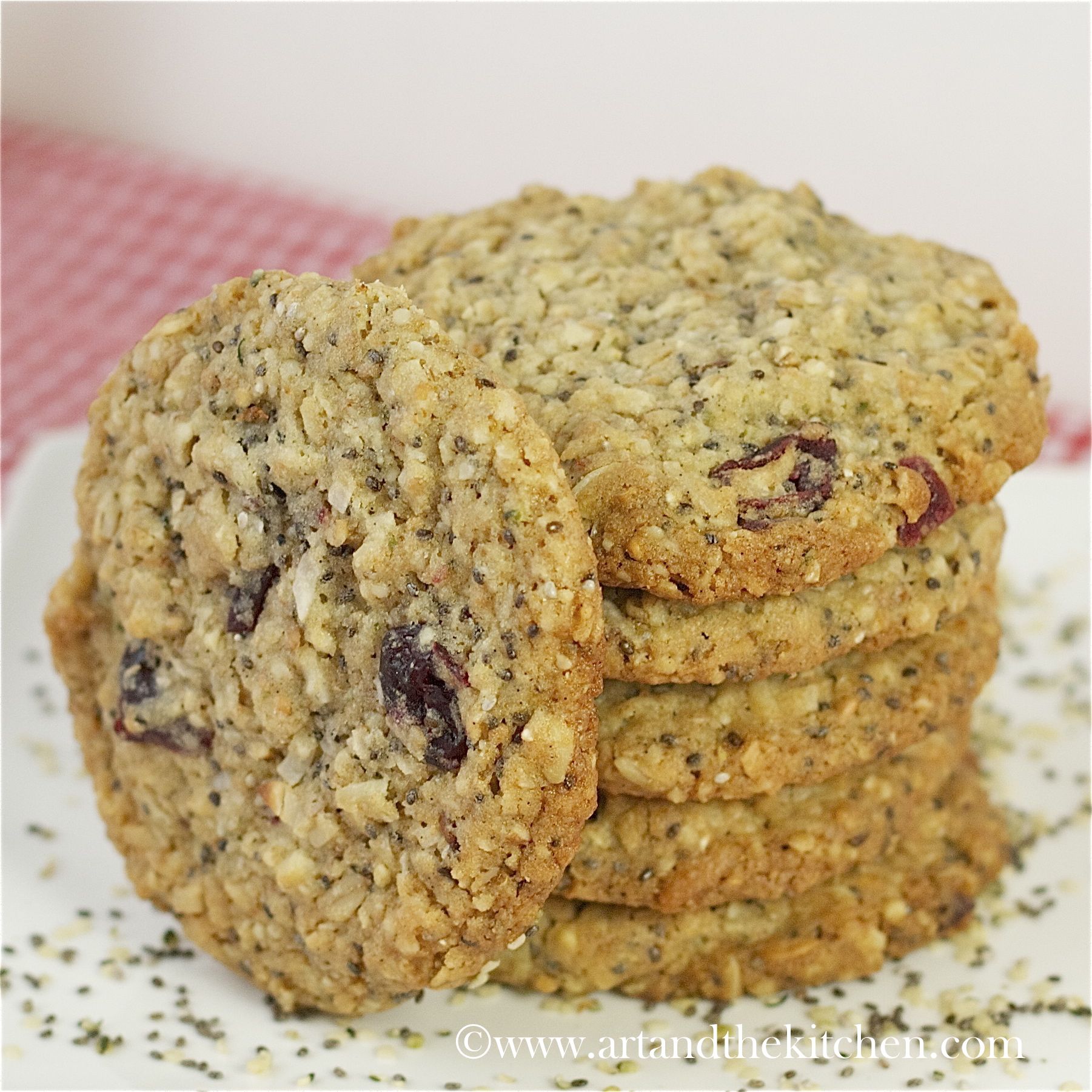 stack of chia, hemp seed oatmeal cookies with one cookie on leaned on side of stack of cookies