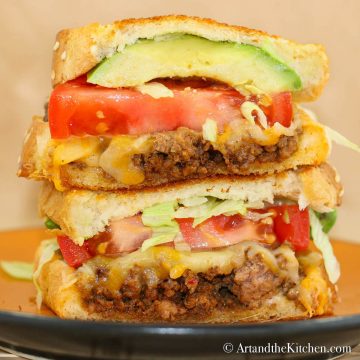 Grilled cheese sandwich with layers of taco flavored beef, tomatoes, lettuce and avocado.