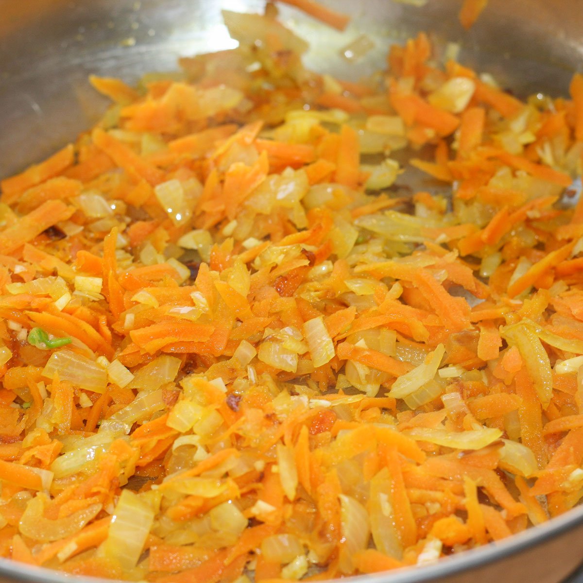 Skillet of sautéed carrots, onion and garlic