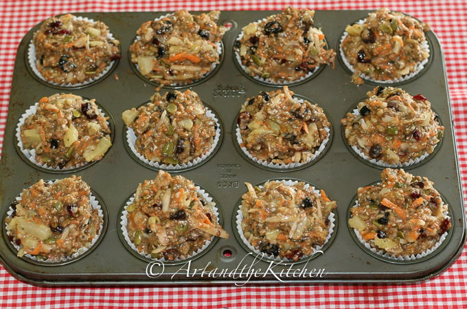 Muffin tin filled with thick batter of healthy muffin mixture.