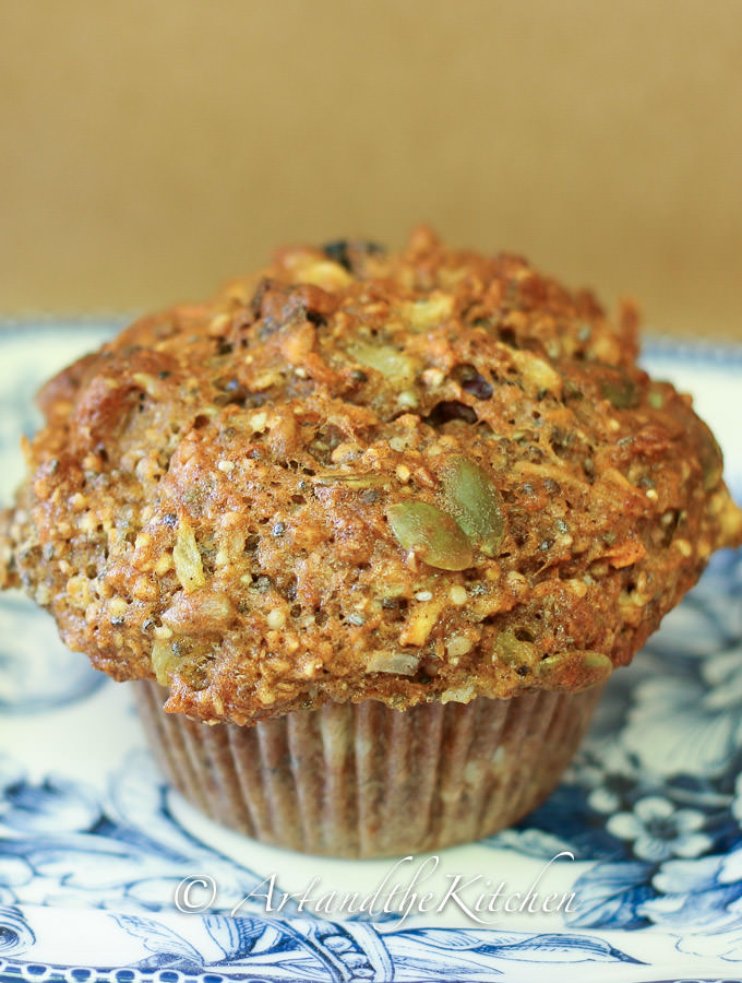 Close up photo of healthy muffin with whole grains, dried fruit, pumpkin and sunflowers and more.