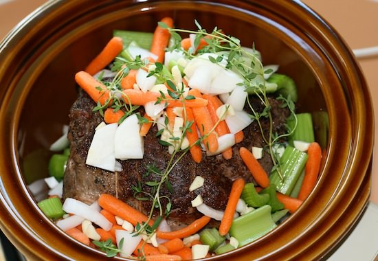 Roast beef and vegetables in a slow cooker.