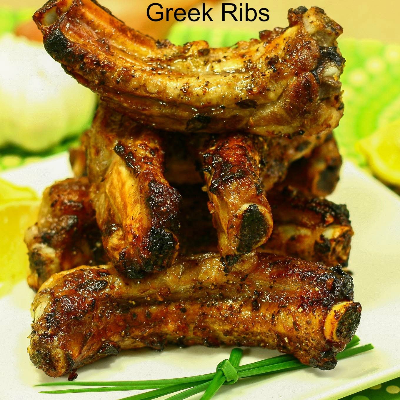 Stack of baked baby back rib pieces with garnished green onion sprig.