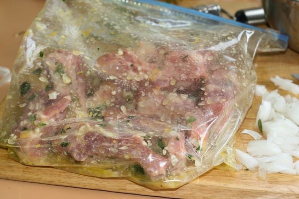 Baby back ribs marinating in plastic zip bag.