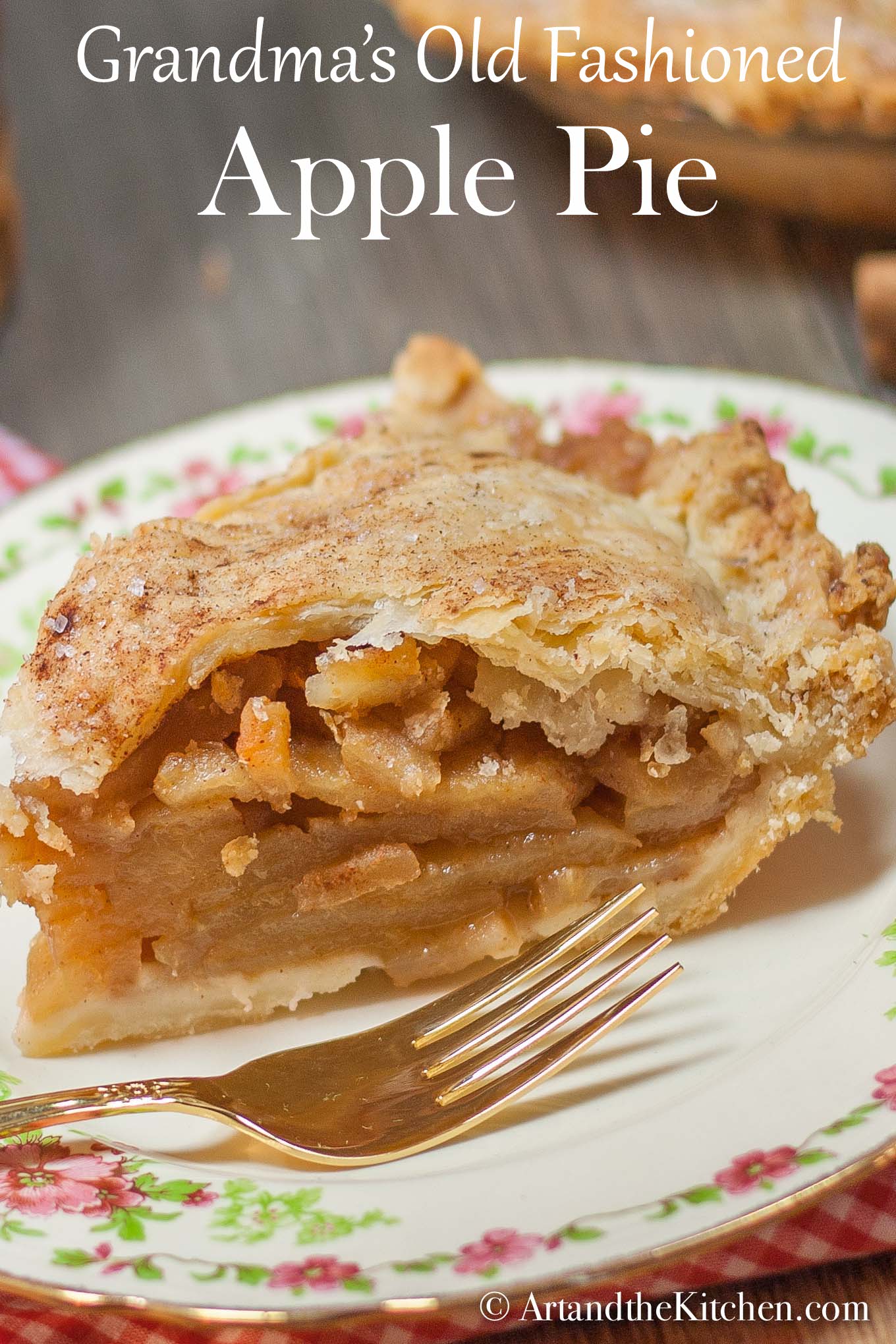 Slice of apple pie on decorative plate with gold plated fork.