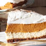 Cream cheese and pumpkin layered pie topped with whipped cream.