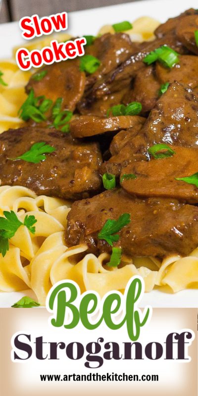 Plate of beef stroganoff with mushrooms on top of broad noodles.