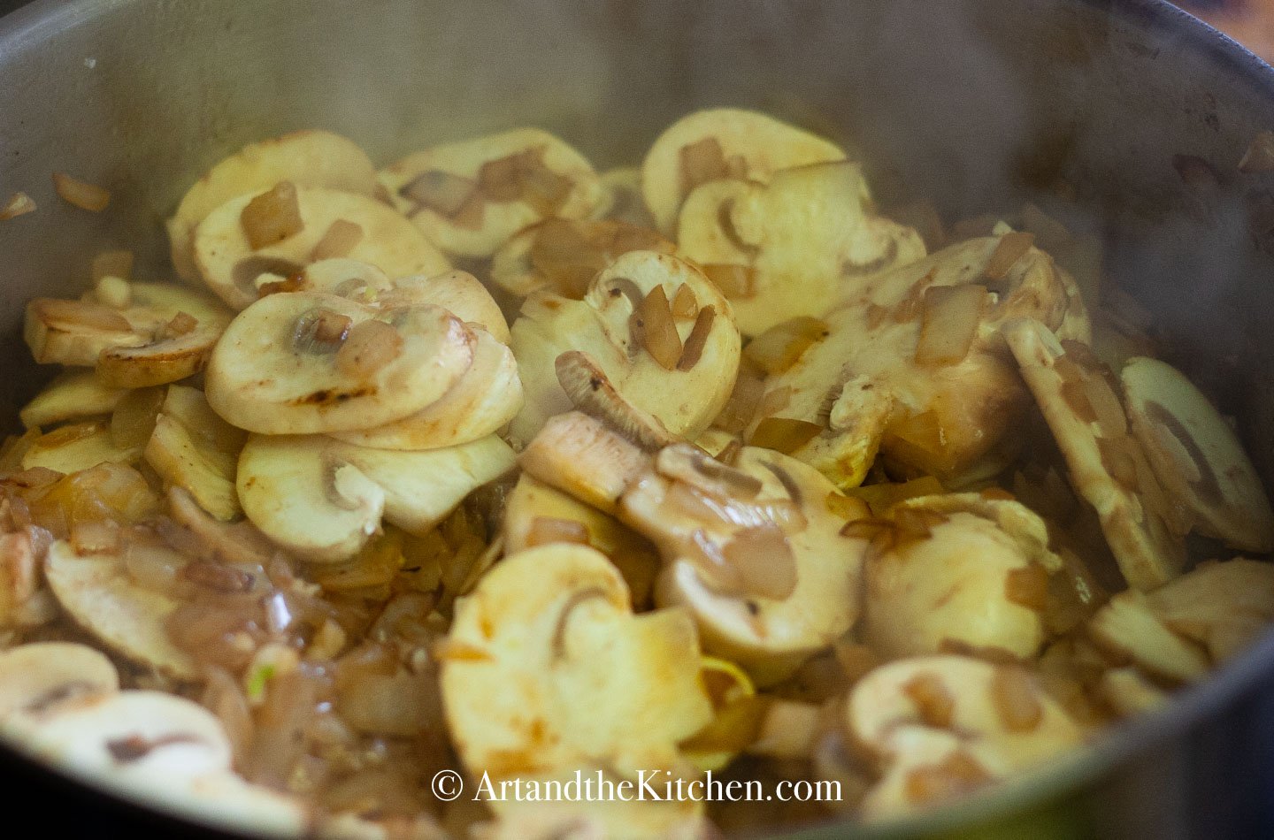 Mushroom, onions and garlic sautéing in pan.