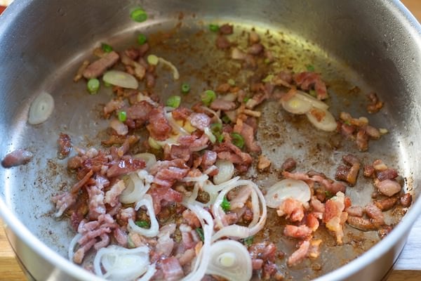 frying pan with pan seared bacon, shallots, garlic and green onions