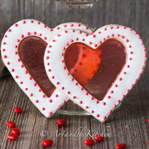 Valentine sugar cookies that are decorated using a stained glass technique.