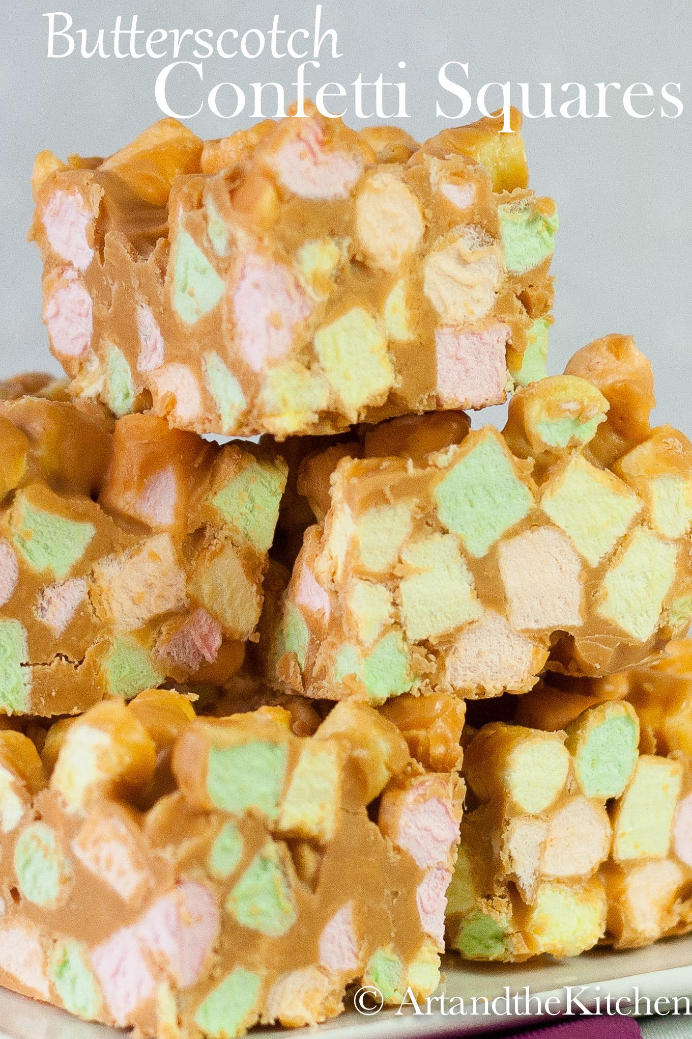 stack of sweet squares made with colorful mini marshmallows, peanut butter and butterscotch chips.