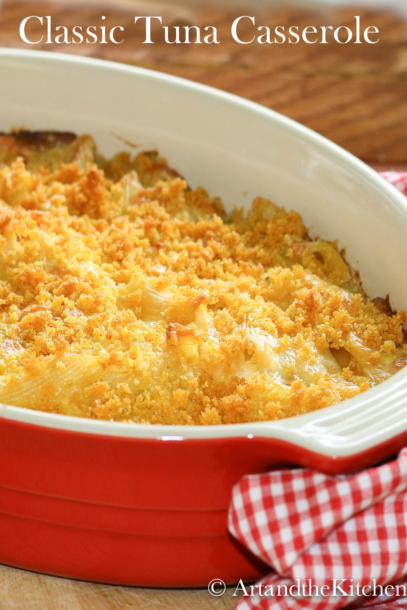 Red stoneware baking pan filled with tuna casserole.