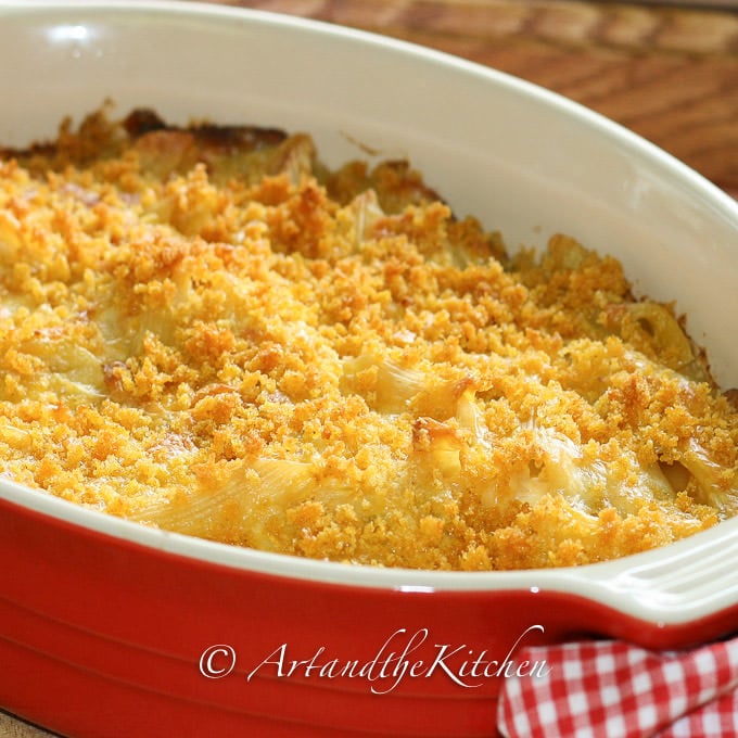 Red stoneware baking pan filled with tuna casserole.