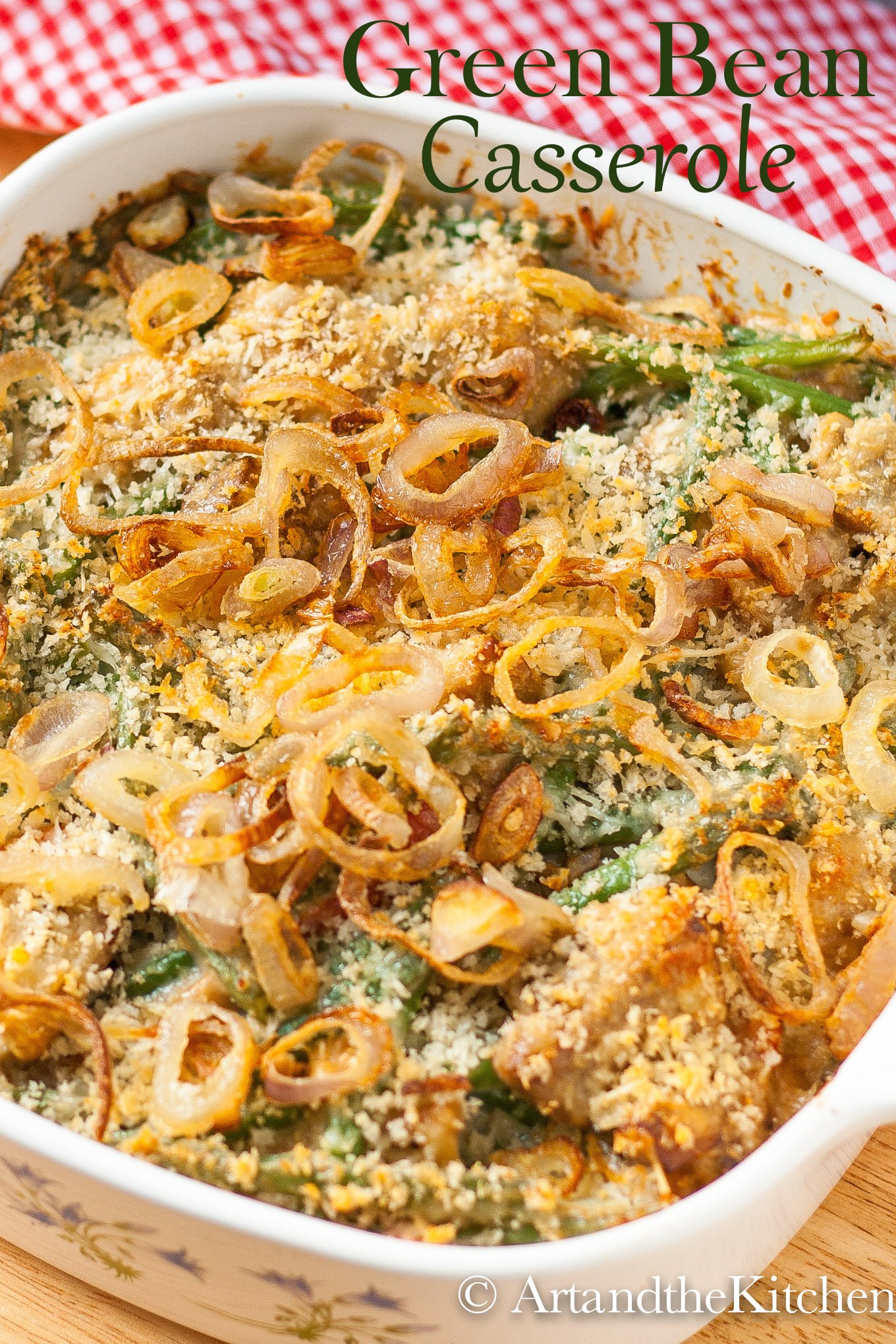 Square baking dish filled with green bean casserole topped with crunchy shallots.