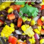 A vibrant Santa Fe salad in a glass bowl showcases colorful corn, black beans, red pepper, and cilantro. Text overlay reads "Santa Fe Salad Cowboy Caviar Style."