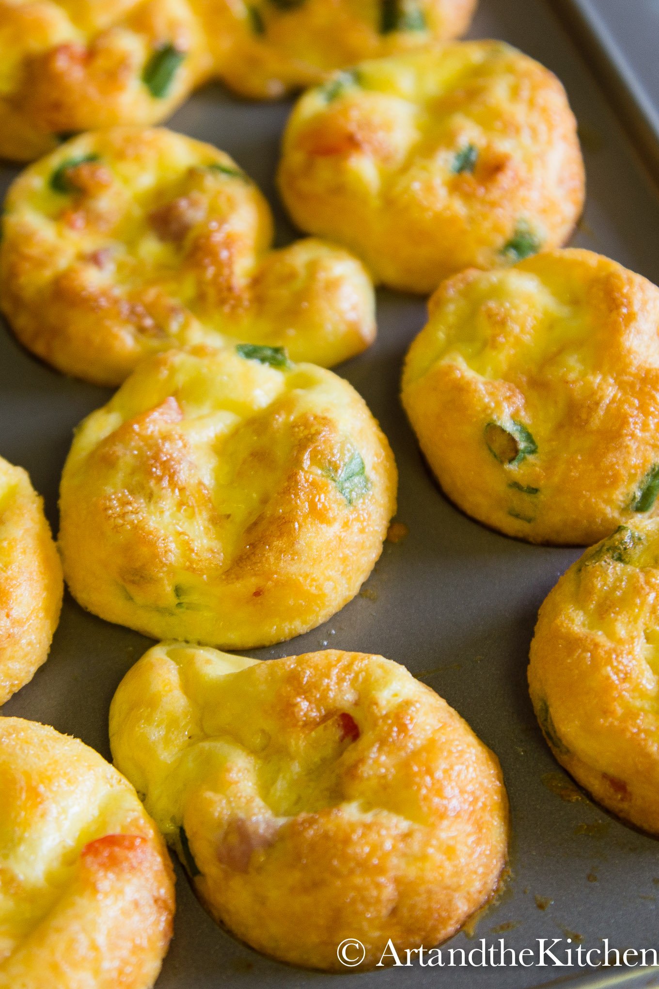 Mini muffin baking pan filled with baked egg bites.