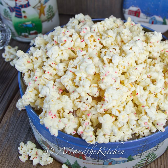 Decorative tin of white chocolate and candy cane popcorn.