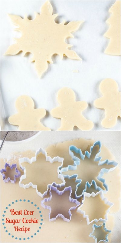 White parchment line baking pan filled with holiday shaped unbaked cookies.