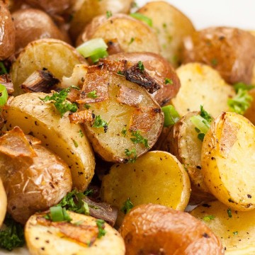 Pile of crispy roasted potatoes with onions.