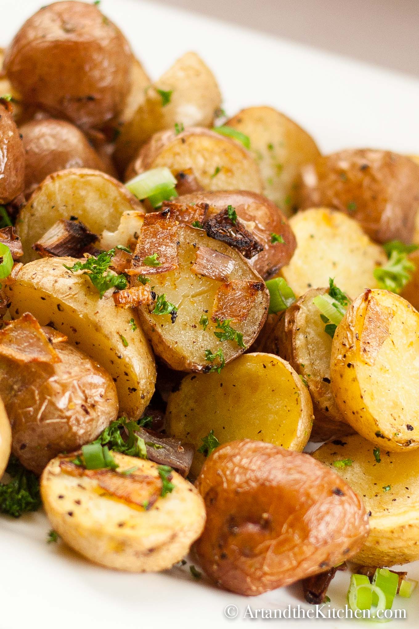 Pile of crispy roasted potatoes with onions.
