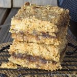 A stack of two date squares on black cooling rack.