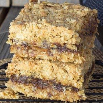 A stack of two date squares on black cooling rack.