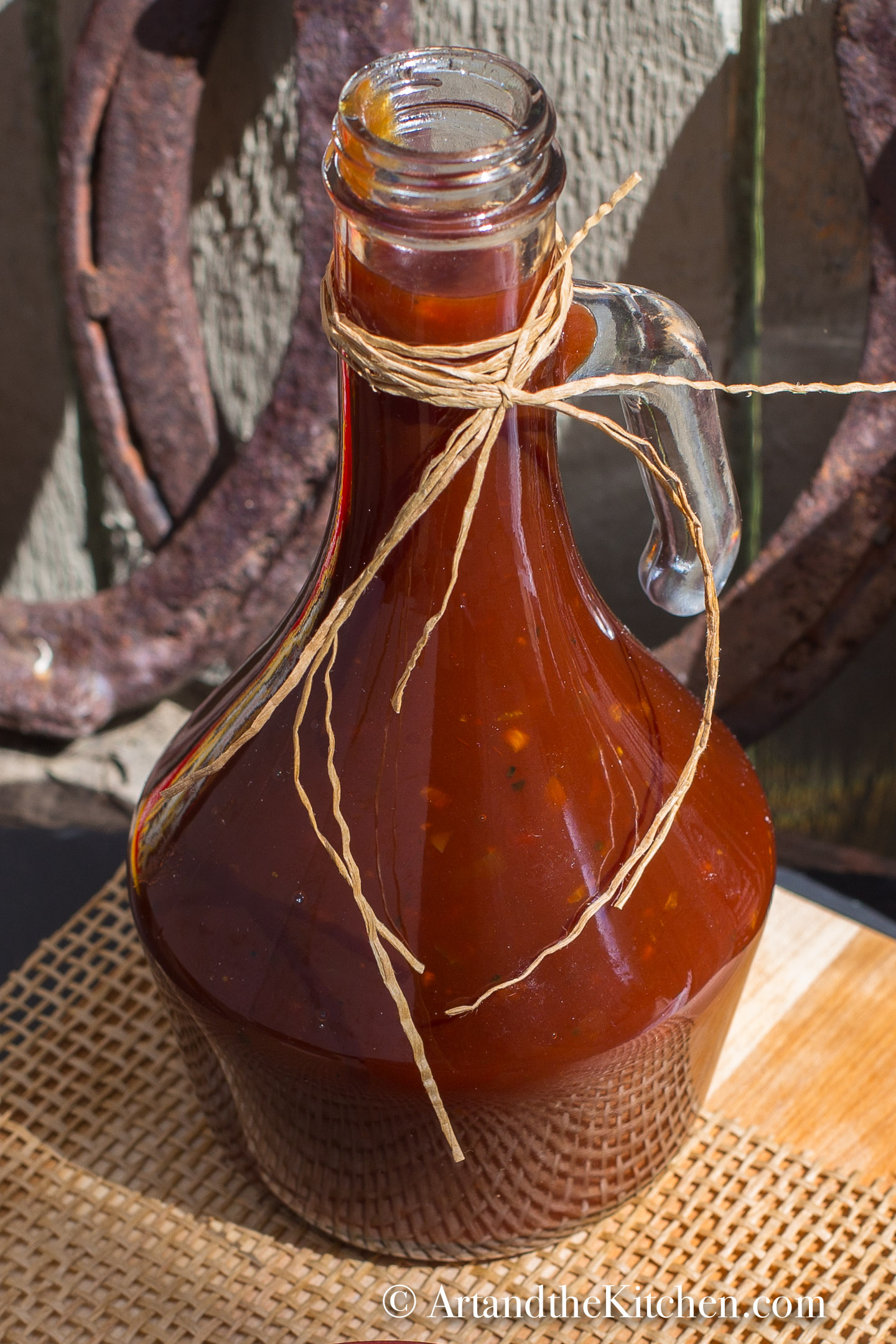 Decorative glass jar filled with homemade BBQ sauce.