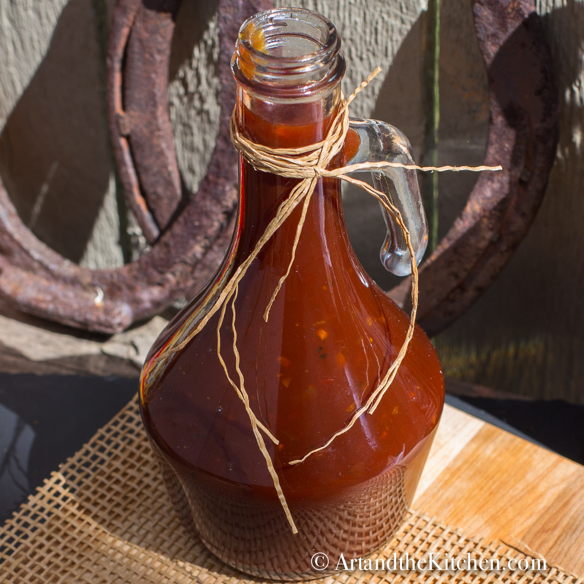 Decorative glass jar filled with homemade BBQ sauce.