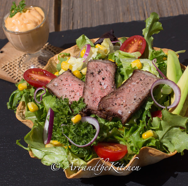 steak salad in baked tortilla shell