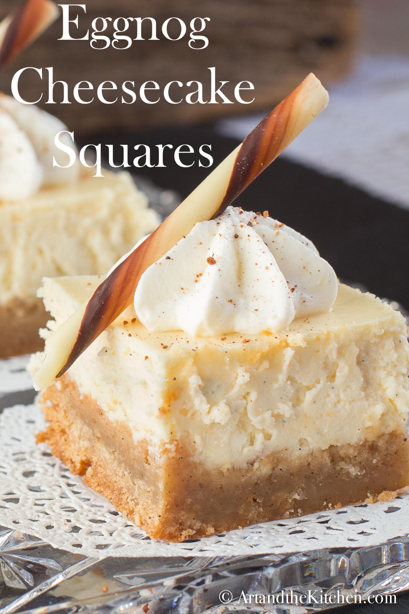These Eggnog Cheesecake Squares are made with a creamy, smooth cheesecake layer and a Holiday spice brownie crust.  via @artandthekitch