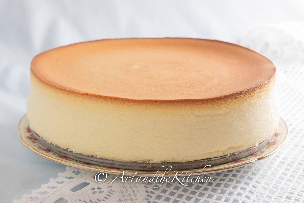 Whole cheesecake with golden brown top, made without a crust.