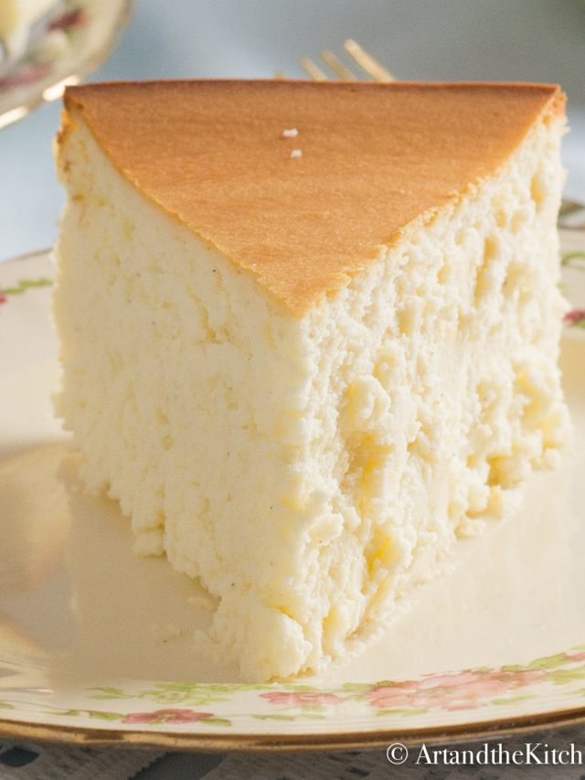 Slice of crustless, plain cheesecake on decorative plate.