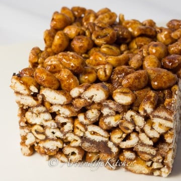 Single piece of square make with puffed wheat and gooey syrup mixture.