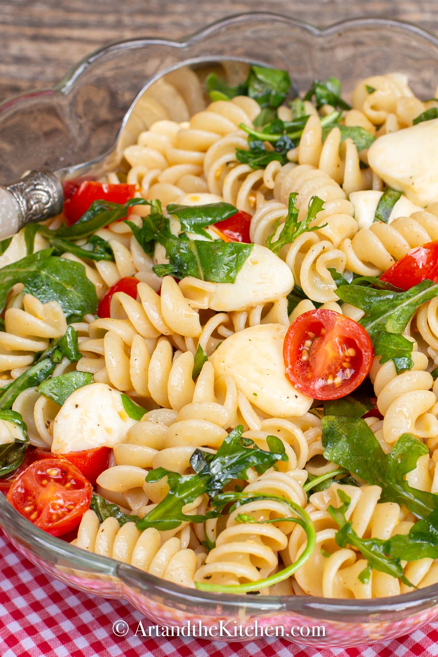 Rotini pasta with bocconcini, tomatoes and arugula.