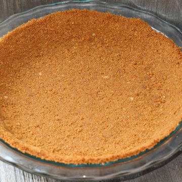 Pie crust made with gingersnaps in a glass pie plate.