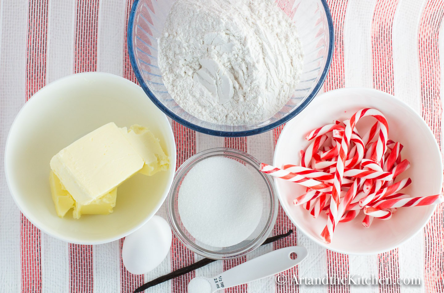 Bowls filled with ingredients for making candy cane sugar cookies.