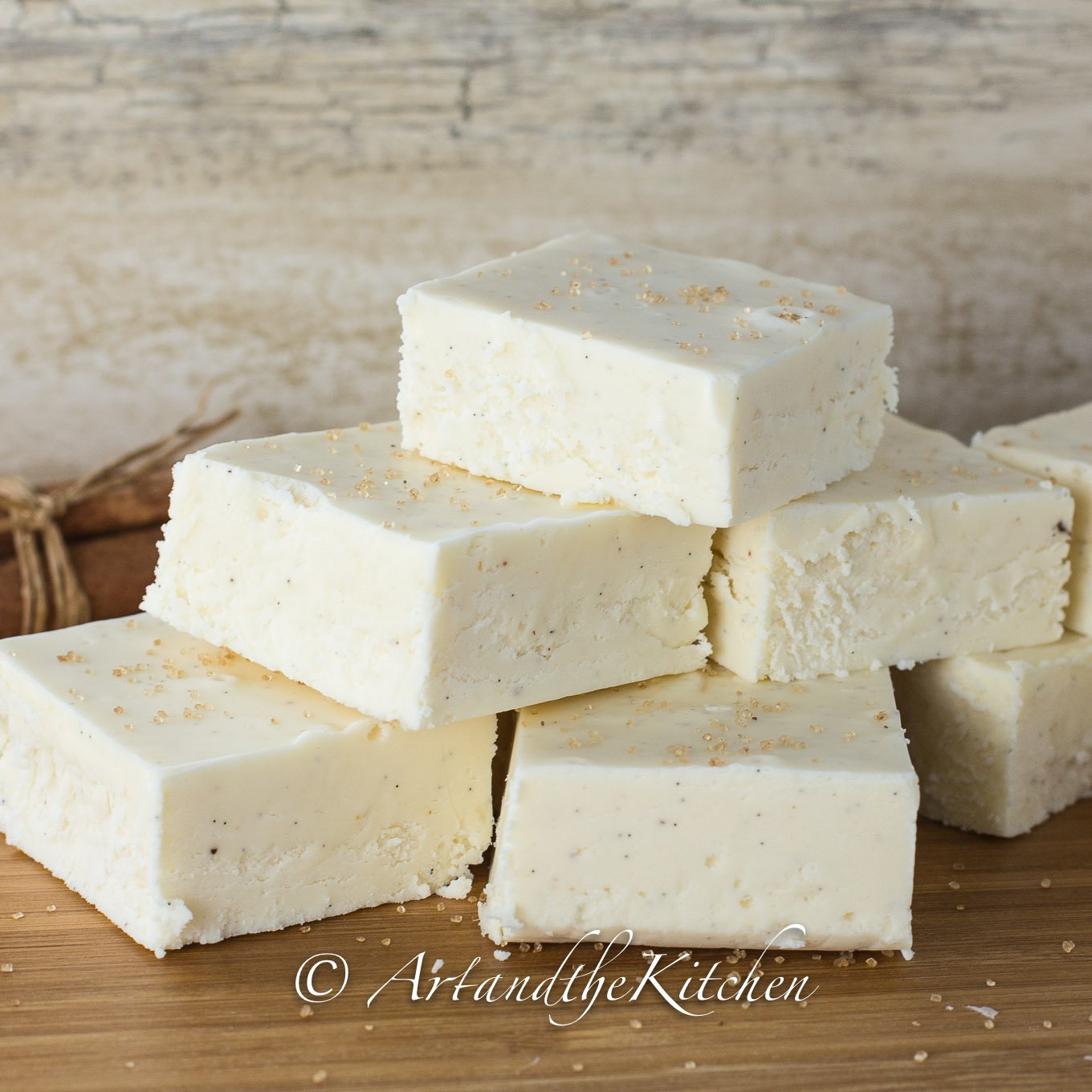 Stack of squares of white fudge made with eggnog flavor.