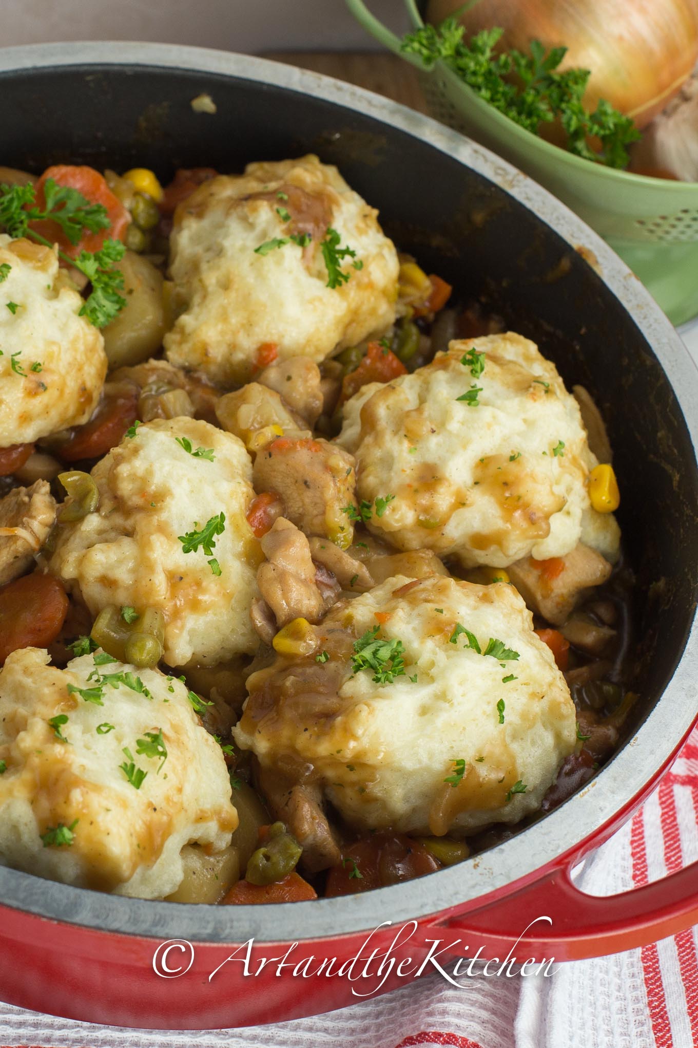 Cast iron pan filled with chicken and dumplings.