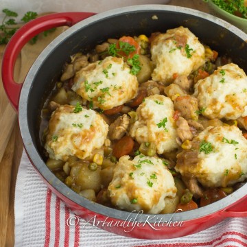 Cast iron pan filled with chicken and dumplings.