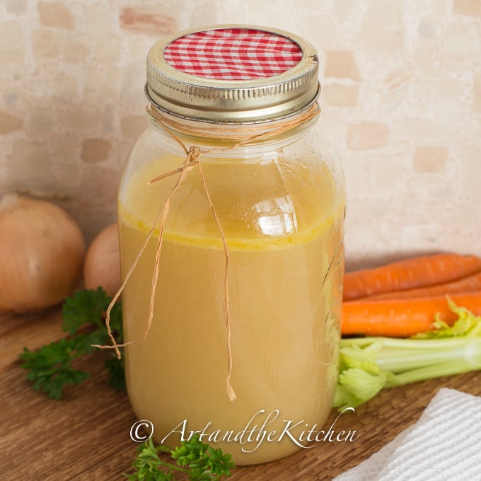 Glass jar of homemade chicken stock.