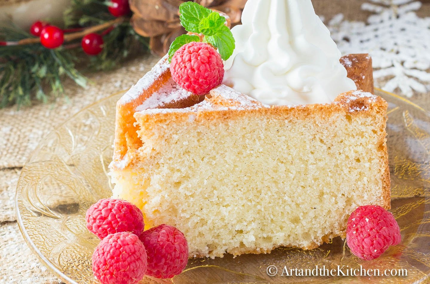 Slice of bundt cake made with eggnog, topped with whipped cream and fresh raspberries.