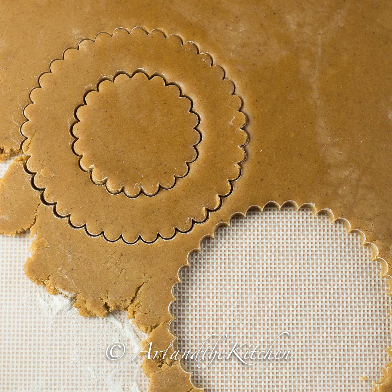 Rolled out gingerbread dough cut into circle shapes.